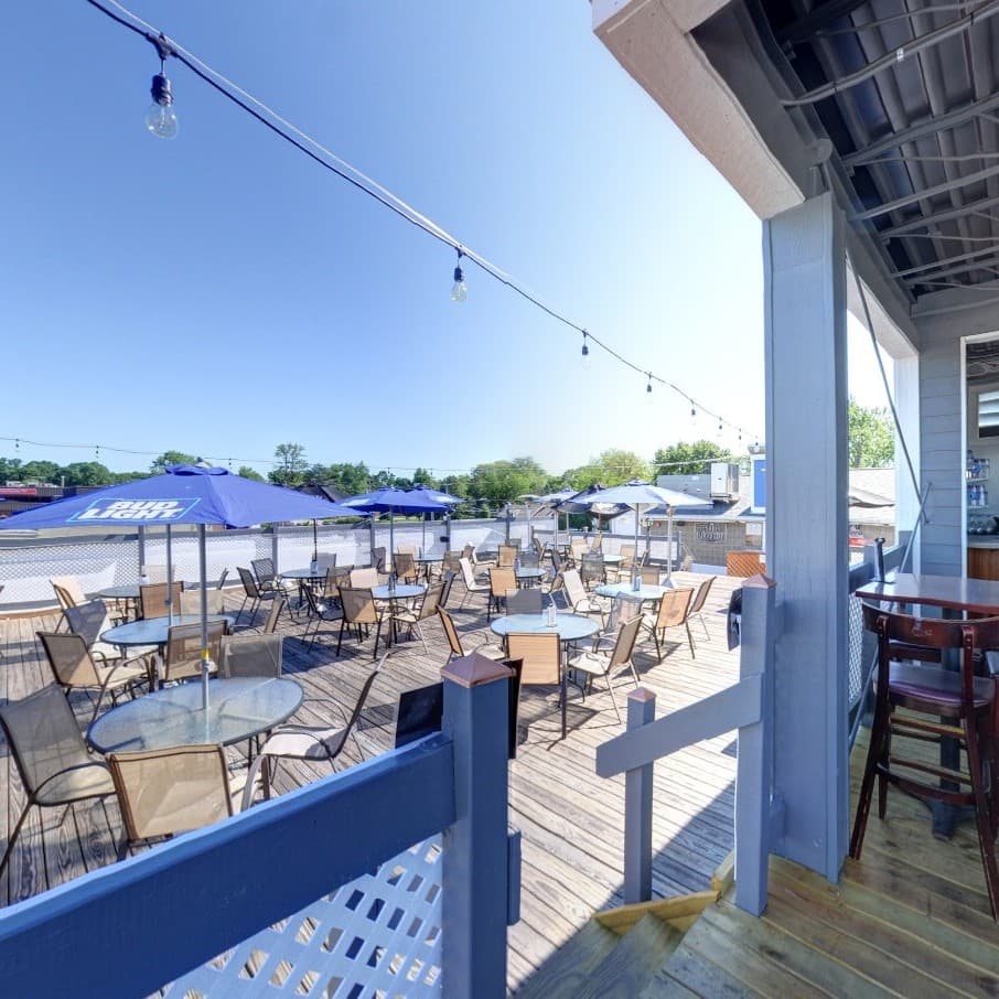 Outdoor rooftop seating with tables and chairs at Rooftop Johnnys Palos Heights IL